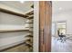 Closet with wooden shelves next to open office with a barn door at 560 John Wesley Dobbs Ave, Atlanta, GA 30312