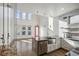 Bright kitchen with white cabinets, concrete countertops, gas range and a farm style sink in the island at 560 John Wesley Dobbs Ave, Atlanta, GA 30312