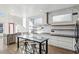 Open concept kitchen features stainless steel appliances, modern cabinets, a large island and eat-in table at 560 John Wesley Dobbs Ave, Atlanta, GA 30312
