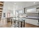 Modern kitchen with stainless steel appliances, an island sink and an eat-in table in the background at 560 John Wesley Dobbs Ave, Atlanta, GA 30312