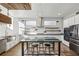 Bright kitchen with a large island, stainless steel appliances, floating wood shelves and eat-in table at 560 John Wesley Dobbs Ave, Atlanta, GA 30312