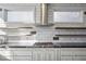 Close up of modern kitchen features floating shelves, stainless steel appliances and bright subway tile at 560 John Wesley Dobbs Ave, Atlanta, GA 30312