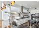 Bright kitchen with stainless steel appliances, island sink, modern cabinets and floating wood shelves at 560 John Wesley Dobbs Ave, Atlanta, GA 30312