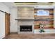 Living room showcasing a concrete fireplace, wood accent wall, and a sliding barn door at 560 John Wesley Dobbs Ave, Atlanta, GA 30312