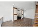 Cozy living room featuring a bar area with sliding barn doors and hardwood floors at 560 John Wesley Dobbs Ave, Atlanta, GA 30312