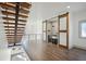 Open floorplan with modern staircase, leading to a wet bar with sliding barn doors and stainless sink at 560 John Wesley Dobbs Ave, Atlanta, GA 30312