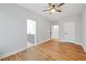 Bright bedroom featuring hardwood floors, ceiling fan, and an ensuite bathroom entrance at 2195 Springdale Sw Rd, Atlanta, GA 30315