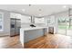 Modern kitchen with white cabinets, stainless steel appliances, and a large center island with marble countertops at 2195 Springdale Sw Rd, Atlanta, GA 30315