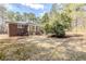 Backyard view showing patio, brick home, lawn area, and mature trees at 3435 Macland Rd, Powder Springs, GA 30127