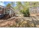 Backyard featuring brick home exterior, a patio, and mature trees at 3435 Macland Rd, Powder Springs, GA 30127