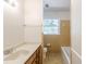 Bathroom featuring a vanity with a sink, a window, and a bathtub with tile surround at 3435 Macland Rd, Powder Springs, GA 30127