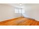 Sunlit bedroom featuring gleaming hardwood floors and neutral walls with large windows at 3435 Macland Rd, Powder Springs, GA 30127