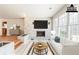 Bright living room with large windows and a stylish fireplace, virtually staged at 3435 Macland Rd, Powder Springs, GA 30127
