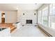 Sunlit living room featuring a charming brick fireplace and large windows at 3435 Macland Rd, Powder Springs, GA 30127