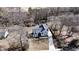Aerial view of a home with a long driveway surrounded by mature trees and an expansive front lawn at 510 Forest St, Buford, GA 30518