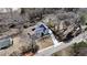 Aerial shot of property featuring a grey roof, long driveway and detached garage surrounded by many deciduous trees at 510 Forest St, Buford, GA 30518