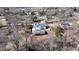 Aerial view of home with a grey roof, long driveway, and detached garage nestled among many trees at 510 Forest St, Buford, GA 30518