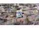 An aerial view of the home showcases a grey roof, long driveway, and detached garage surrounded by lush trees at 510 Forest St, Buford, GA 30518