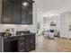 Bar area with dark cabinets, light walls, and views to sitting area and kitchen at 510 Forest St, Buford, GA 30518