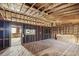 Unfinished basement featuring exposed wood framing, a concrete floor, and natural light at 510 Forest St, Buford, GA 30518