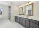 Bathroom featuring double vanity, gold fixtures, large mirrors, and glass shower at 510 Forest St, Buford, GA 30518