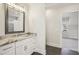 Well-lit bathroom featuring a granite-topped vanity, sleek fixtures, and gray tile flooring at 510 Forest St, Buford, GA 30518