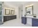 Bathroom featuring double vanity, gold fixtures, large mirrors, and glass shower at 510 Forest St, Buford, GA 30518