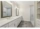 Elegant bathroom with double vanity, gray tile flooring, and a large glass-enclosed shower at 510 Forest St, Buford, GA 30518