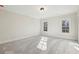 Spacious bedroom with neutral walls, soft carpeting, and plenty of natural light from windows at 510 Forest St, Buford, GA 30518