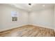 Inviting bedroom with hard wood floors, natural light from window, and modern recessed lighting at 510 Forest St, Buford, GA 30518