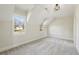 Cozy bedroom with sloped ceilings, soft carpeting, and natural light from two windows at 510 Forest St, Buford, GA 30518