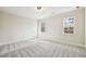 Bright bedroom featuring neutral walls, plush carpeting, and natural light from two windows at 510 Forest St, Buford, GA 30518