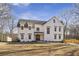 Beautiful two-story modern farmhouse featuring a large front yard and dark shingle roof at 510 Forest St, Buford, GA 30518