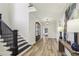 Bright entryway features hardwood floors, stairs, a dark wood door, and natural light at 510 Forest St, Buford, GA 30518