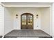 Close up of beautiful arched double front doors with sidelights and stone porch at 510 Forest St, Buford, GA 30518