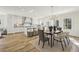 Bright open-concept kitchen with white cabinets, island seating, and dining area at 510 Forest St, Buford, GA 30518