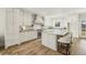 Stunning kitchen with white cabinets, granite countertops, stainless steel appliances, and an island with seating at 510 Forest St, Buford, GA 30518