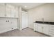 Functional laundry room with ample cabinet space and a utility sink at 510 Forest St, Buford, GA 30518
