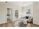 A well-lit seating area has hardwood floors, natural light, and access to a bathroom at 510 Forest St, Buford, GA 30518