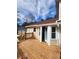 Inviting wooden deck with railing and chair, leading to a charming home exterior with neutral siding and a sunny ambiance at 956 S Deshon Rd, Lithonia, GA 30058