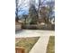 Spacious concrete driveway next to the lawn area and a wooden fence at 956 S Deshon Rd, Lithonia, GA 30058