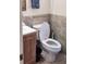 Bathroom features a tiled accent wall and a toilet with an open lid at 956 S Deshon Rd, Lithonia, GA 30058