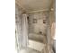 Bathroom featuring a bathtub, shower curtain, and marble tile at 956 S Deshon Rd, Lithonia, GA 30058