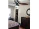 Cozy bedroom features a ceiling fan, a round mirror, and an closet at 956 S Deshon Rd, Lithonia, GA 30058