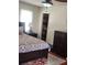 Comfortable bedroom with dark furniture, a ceiling fan, and a walk-in closet at 956 S Deshon Rd, Lithonia, GA 30058