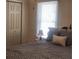 A comfy bedroom with a big window and soft lamp at 956 S Deshon Rd, Lithonia, GA 30058