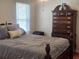 A comfy bedroom with a large dresser and window at 956 S Deshon Rd, Lithonia, GA 30058