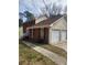 Well-maintained home featuring a two-car garage, brick accents, and a tidy lawn at 956 S Deshon Rd, Lithonia, GA 30058