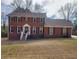 Charming two-story brick home with a well-manicured lawn and classic red shutters, offering timeless curb appeal at 956 S Deshon Rd, Lithonia, GA 30058