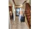 Inviting hallway featuring tile flooring, a wooden staircase, and tasteful decor, creating a warm and welcoming ambiance at 956 S Deshon Rd, Lithonia, GA 30058